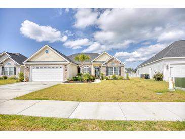 Attractive one-story home with a brick and siding exterior, two-car garage, and well-manicured lawn at 520 Hobie Cat Rd., Myrtle Beach, SC 29588