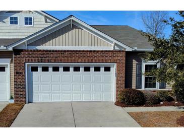 Attached home featuring a white garage door with a brick and siding exterior at 900 British Ln. # 1187, Myrtle Beach, SC 29579