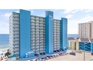 Bright blue multistory condo building, named Water's Edge, overlooks the beach and ocean at 1012 N Waccamaw Dr. # 902, Murrells Inlet, SC 29576