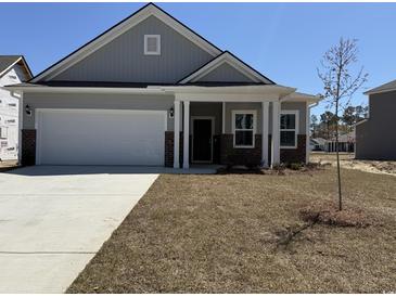 Charming single-Gathering home with a two-car garage and welcoming front porch at 1312 Winding Creek Way, Myrtle Beach, SC 29588