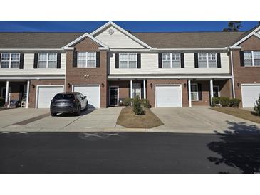 Brick front of townhome with 2-car garage and landscaping at 270 Connemara Dr. # C, Myrtle Beach, SC 29579