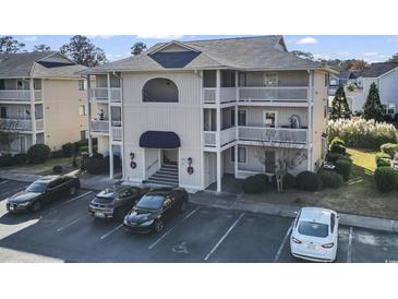 Front view of a three-story building with parking at 4278 Pinehurst Circle # W8, Little River, SC 29566