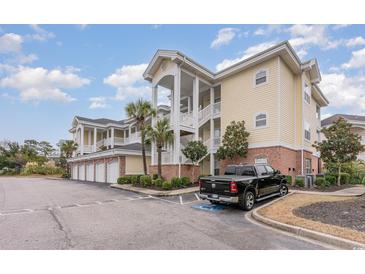Exterior of 3-story condo building with parking and landscaping at 4872 Dahila Ct. # 301, Myrtle Beach, SC 29577