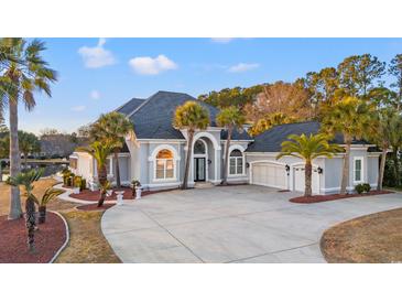 Luxury home with a large driveway and mature landscaping at 117 Ashley River Rd., Myrtle Beach, SC 29588