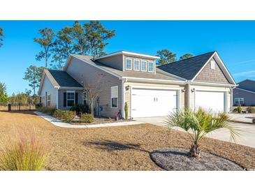 Two-story townhome with attached garage and landscaped yard at 1574 Jardine Loop, Little River, SC 29566