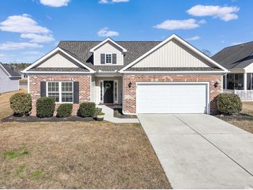 Brick ranch house with attached garage and landscaping at 169 Riverwatch Dr., Conway, SC 29527