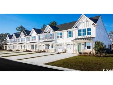 Row of charming townhouses with white exteriors and green accents at 273 Bent Green Ct. # 76G, Murrells Inlet, SC 29576