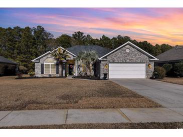 Brick ranch home with two-car garage and landscaped lawn at 3737 Kingsley Dr., Myrtle Beach, SC 29588