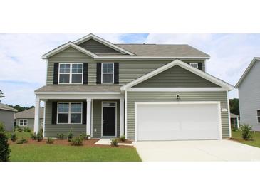 Two-story house with green siding, white garage door, and landscaping at 4027 Smokey Dr, Conway, SC 29526