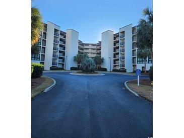 Exterior of building with parking and landscaping at 417 S Dunes Dr., Pawleys Island, SC 29585