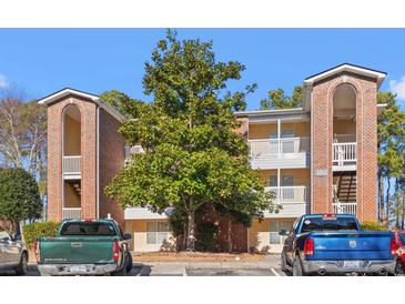 Brick condo building with ample parking and landscaping at 4243 Villa Dr. # 502, Little River, SC 29566