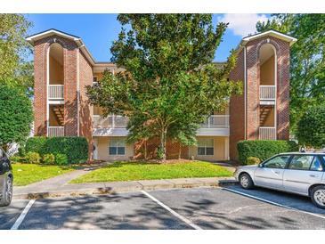 Brick building exterior with landscaping and parking at 4273 Villas Dr. # 1006, Little River, SC 29566