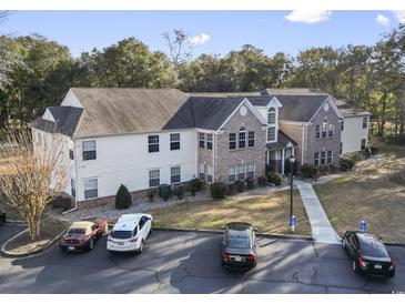 Two-story building with brick and siding, ample parking, and landscaping at 4323 Lotus Ct. # G, Murrells Inlet, SC 29576