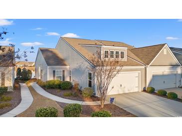 Charming home with a two-car garage, well-manicured lawn, and inviting walkway at 4451 Livorn Loop # 4451, Myrtle Beach, SC 29579