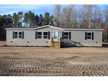 Gray vinyl siding house with wooden steps and a small yard at 5225 Hwy 712, Galivants Ferry, SC 29544