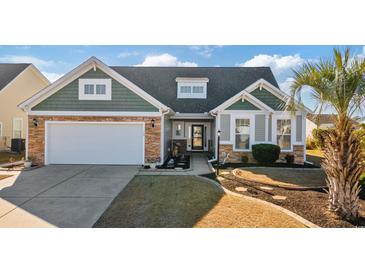 Inviting curb appeal featuring stone and shingle accents at 569 Miromar Way, Myrtle Beach, SC 29588