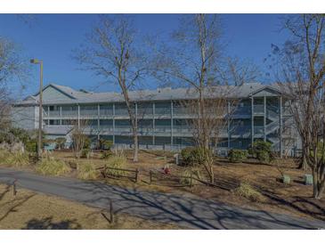 Exterior view of a three-story building with balconies and landscaping at 5905 South Kings Hwy. # 4205, Myrtle Beach, SC 29575