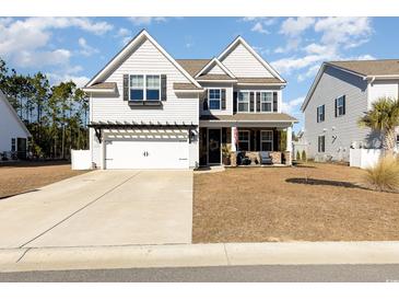 Two-story home with stone accents and a welcoming front porch at 771 Flowering Branch Ave., Little River, SC 29566