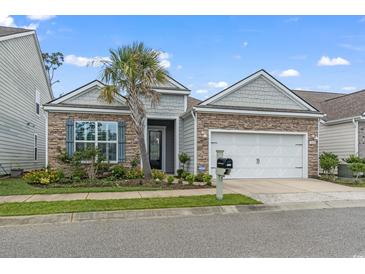 Curb appeal abounds with this charming home, showcasing stone and shingle accents, a welcoming porch, and a two-car garage at 912 Lorenzo Dr., North Myrtle Beach, SC 29582