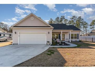 Charming one-story house with attached garage and landscaped yard at 9815 W Highway 19, Loris, SC 29569