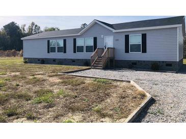 Gray single-wide manufactured home with gray trim and landscaping at 122 Willie Mays Pl., Aynor, SC 29511