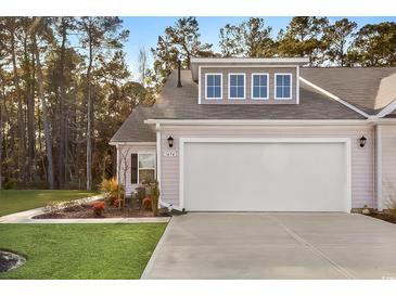 Front exterior of house with garage and landscaping at 1454 Jardine Loop, Little River, SC 29566