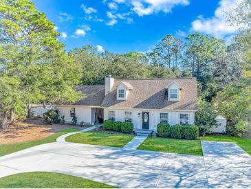 Single-story home with a landscaped yard and driveway at 19 Springfield Rd., Pawleys Island, SC 29585