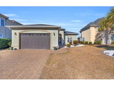 Attractive one-story home with a brown garage door and landscaped yard at 274 Avenue Of The Palms, Myrtle Beach, SC 29579