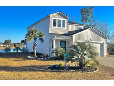 Two-story home with attractive landscaping and lake view at 340 N Reindeer Rd., Surfside Beach, SC 29575