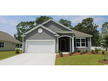 Gray siding, white garage door, and manicured lawn enhance this charming home's curb appeal at 398 Glacier Way, Conway, SC 29526