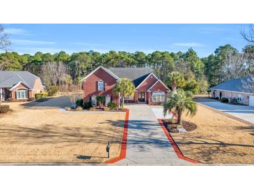 Brick home with large driveway and landscaped yard at 4375 Winged Foot Ct., Myrtle Beach, SC 29579