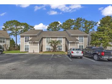 Tan colored building with parking lot and landscaping at 4490 Little River Inn Ln. # 2203, Little River, SC 29566