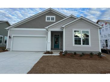 New construction home with gray siding, white garage door, and teal front door at 5439 Shelly Lynn Dr., Myrtle Beach, SC 29579