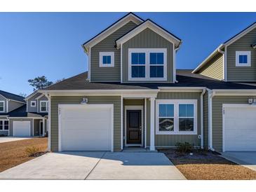 Two-story townhome with gray siding, white garage door, and landscaping at 592 Sea Sparrow St., Myrtle Beach, SC 29588