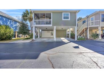 Elevated home with covered porch and parking underneath at 820 9Th Ave. S, North Myrtle Beach, SC 29582