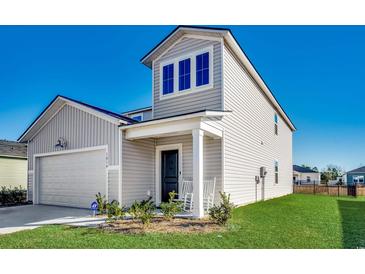 Two-story house with gray siding, a two-car garage, and a rocking chair on the porch at 1014 Tibetan St., Conway, SC 29526