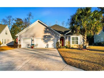 Attractive house with 3-car garage, stone accents, and palm trees at 132 Rivers Edge Dr., Conway, SC 29526