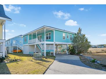 Charming light teal exterior with a spacious elevated deck at 147 Anglers Dr., Murrells Inlet, SC 29576