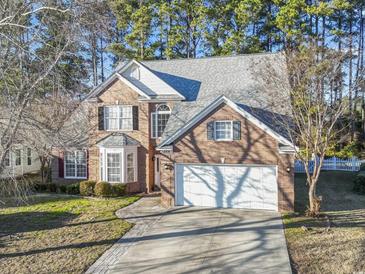 Brick two-story house with a two-car garage and landscaped yard at 394 Blackberry Ln., Myrtle Beach, SC 29579