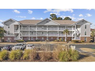 Two-story condo building with ample parking and landscaping at 5750 Oyster Catcher Dr. # 1124, North Myrtle Beach, SC 29582