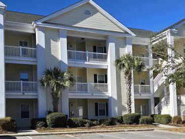 Three-story building with light-colored siding, balconies, and palm trees at 601 Hillside Ave. N # 1623, North Myrtle Beach, SC 29582
