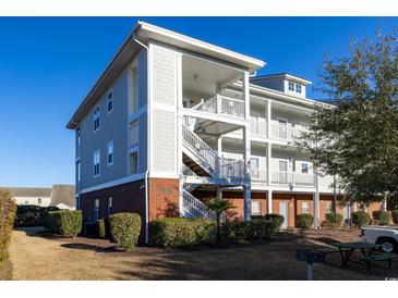 Three-story building with brick and siding, featuring stairs and balconies at 804 Crumpet Ct. # 1151, Myrtle Beach, SC 29579