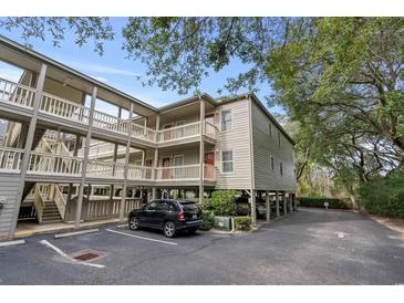 Two-story building with parking and surrounding trees at 107 Toby Ct. # 203-B, North Myrtle Beach, SC 29582