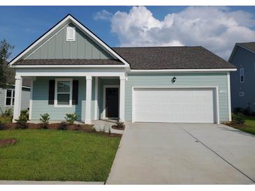 Newly constructed home with light teal siding, white trim, and a two-car garage at 1129 Black Lake Way, Conway, SC 29526