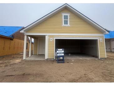 A new construction home features a spacious two-car garage with a neutral exterior at 1252 Lady Bird Way, North Myrtle Beach, SC 29582