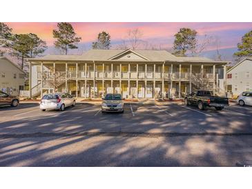 Two-story building with multiple units, ample parking, and a wooded backdrop at 1280 White Tree Ln. # G, Myrtle Beach, SC 29588