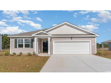 New construction home with two-car garage and landscaped lawn at 1480 Nokota Dr., Conway, SC 29526