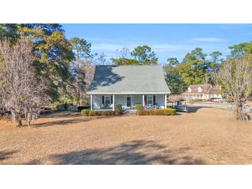 Charming house with front porch and manicured lawn at 16 Johnstone Ln., Georgetown, SC 29440