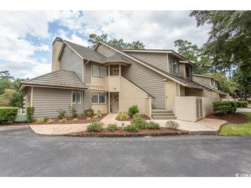 Attractive exterior of a multi-unit dwelling with landscaping and parking at 175 Saint Clears Way # 23A, Myrtle Beach, SC 29572