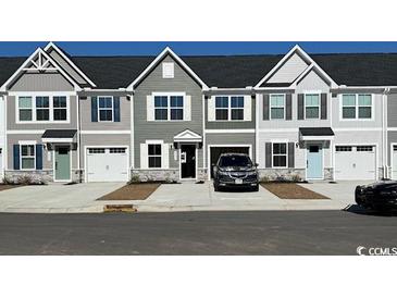 Two-story townhouses with attached garages and neutral-colored siding at 2055 Nw Parow Ln Nw # A, Calabash, NC 28467